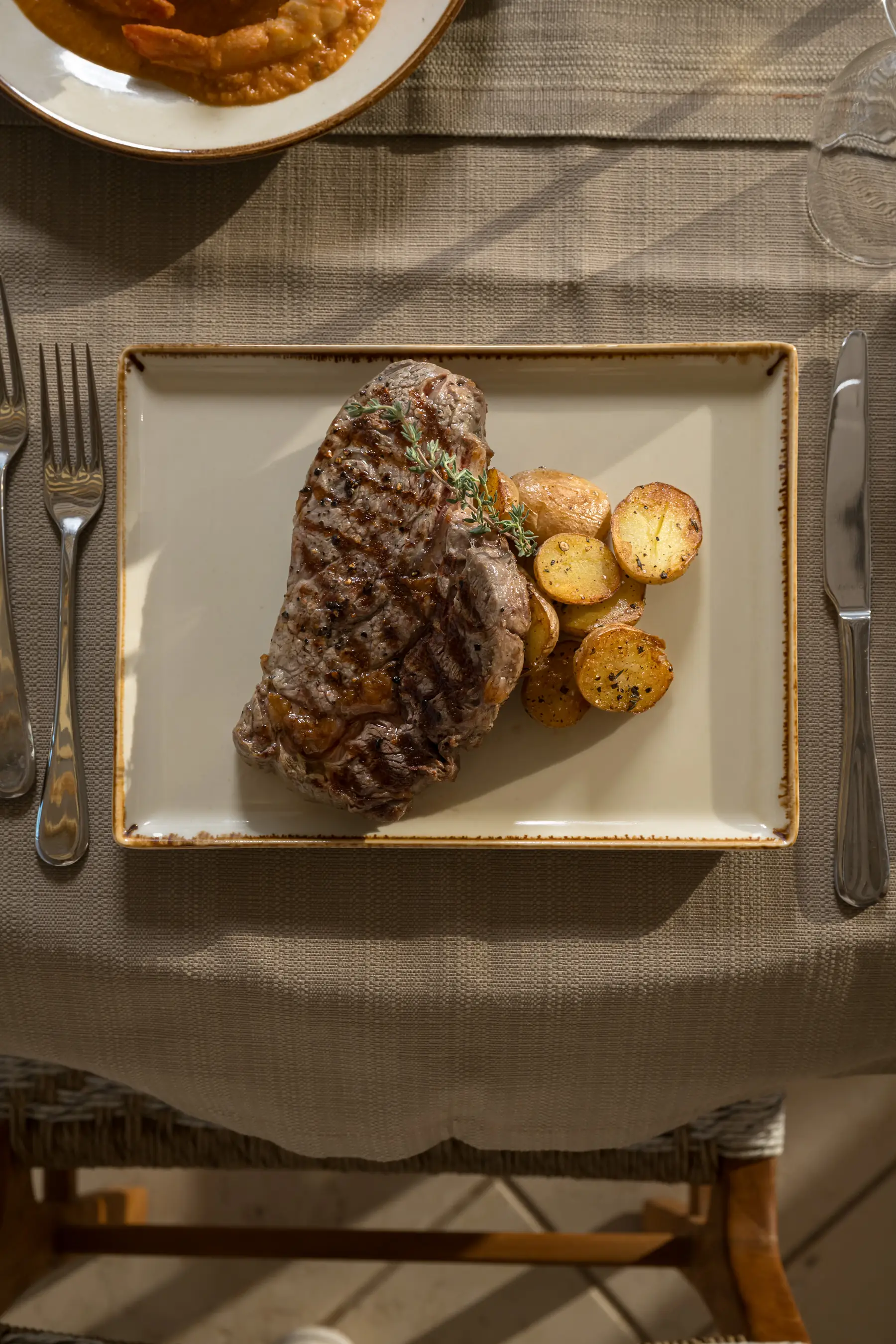 Grilled steak with roasted baby potatoes at Avgi restaurant