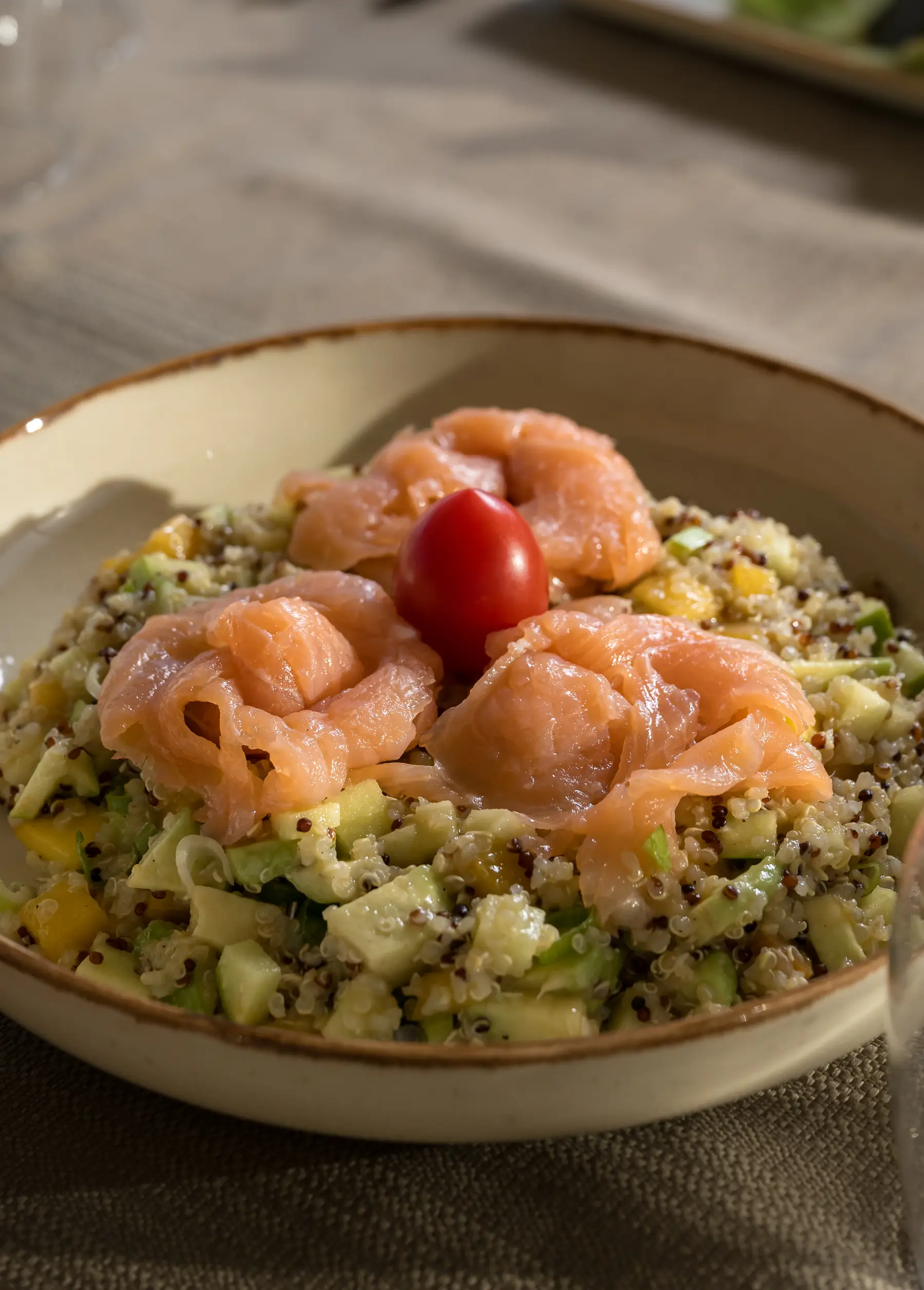 Seafood orzo salad topped with shrimp and cherry tomato