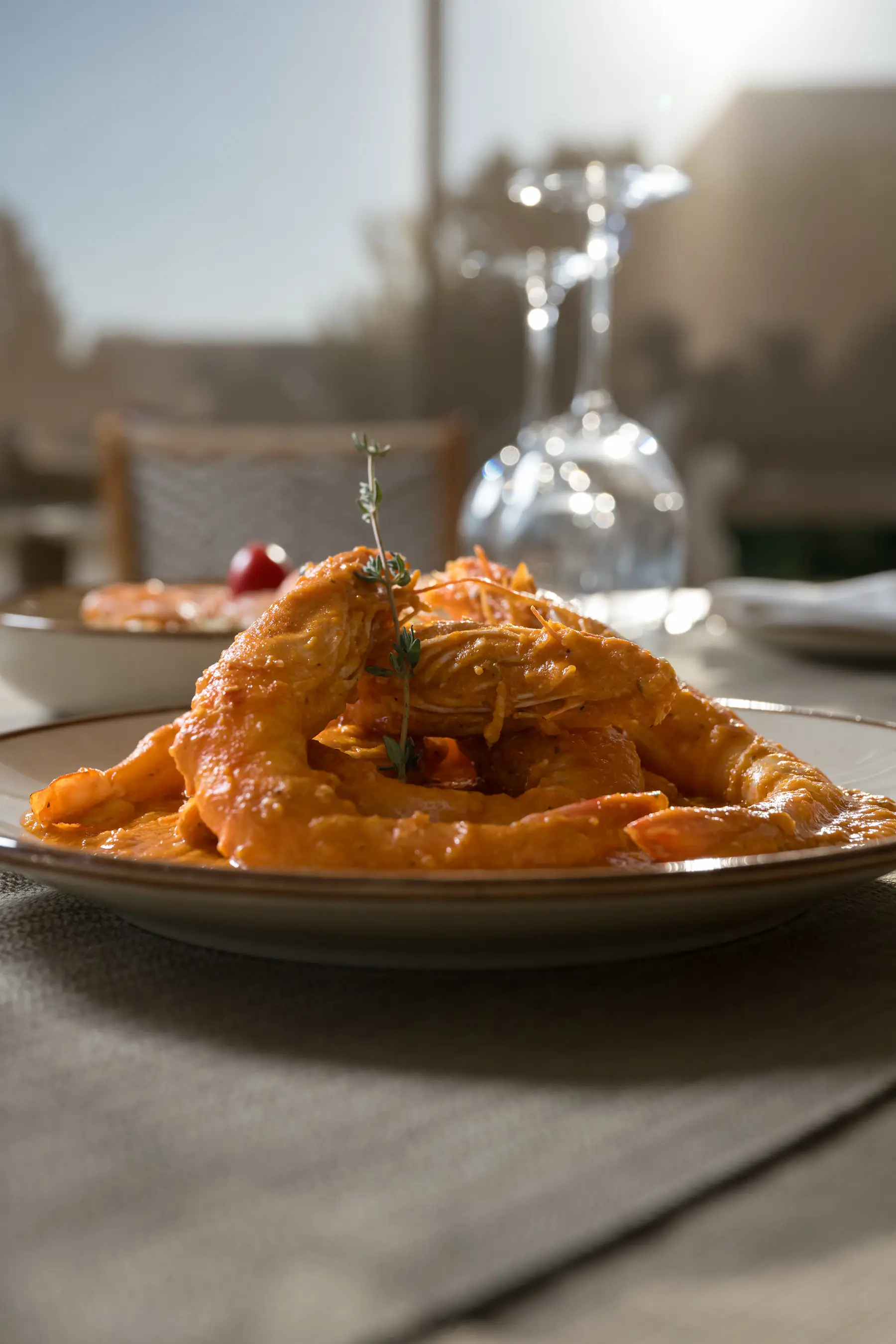 Prawn saganaki in rich tomato sauce served on a white plate