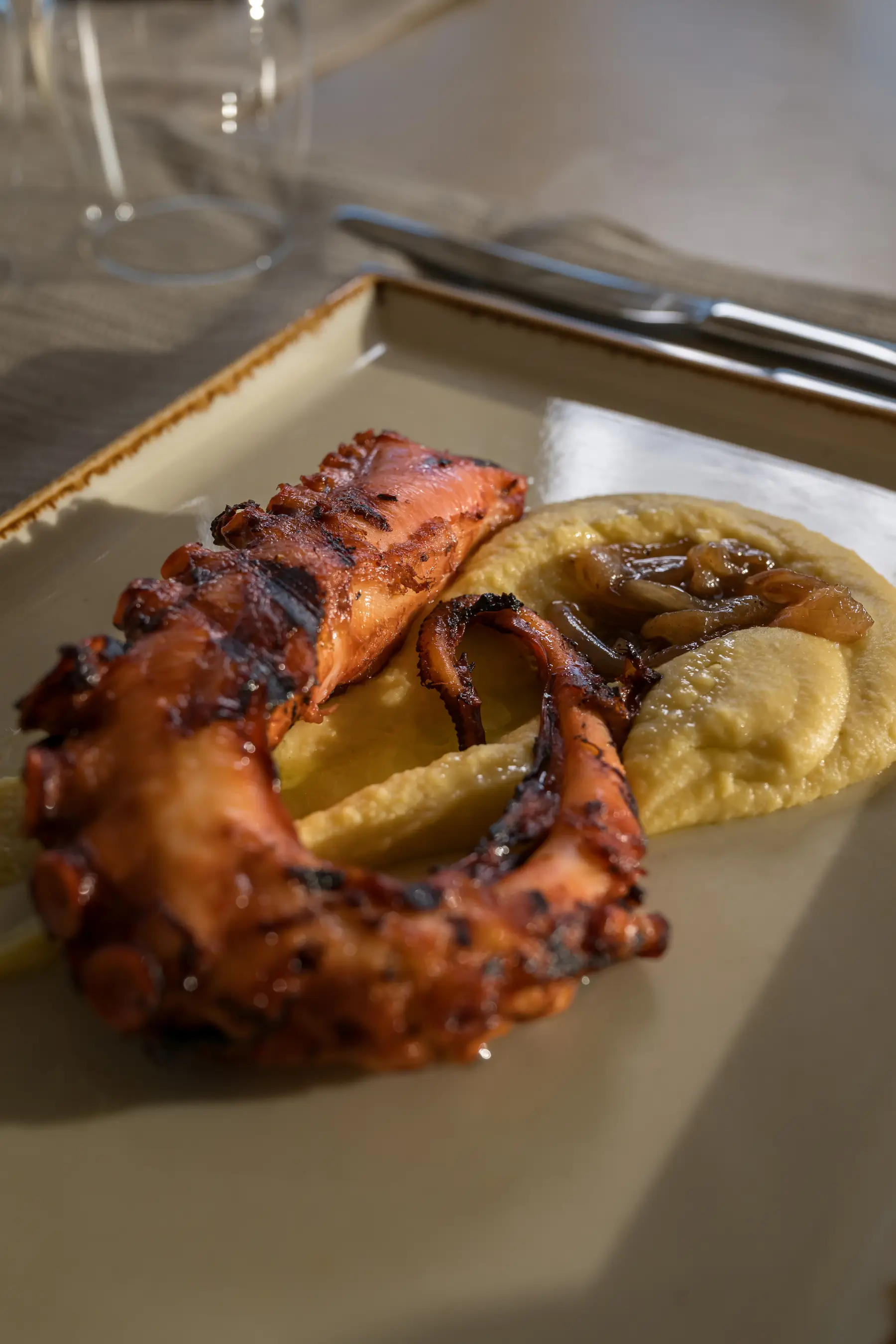 Charcoal-grilled octopus with fava puree and island herbs