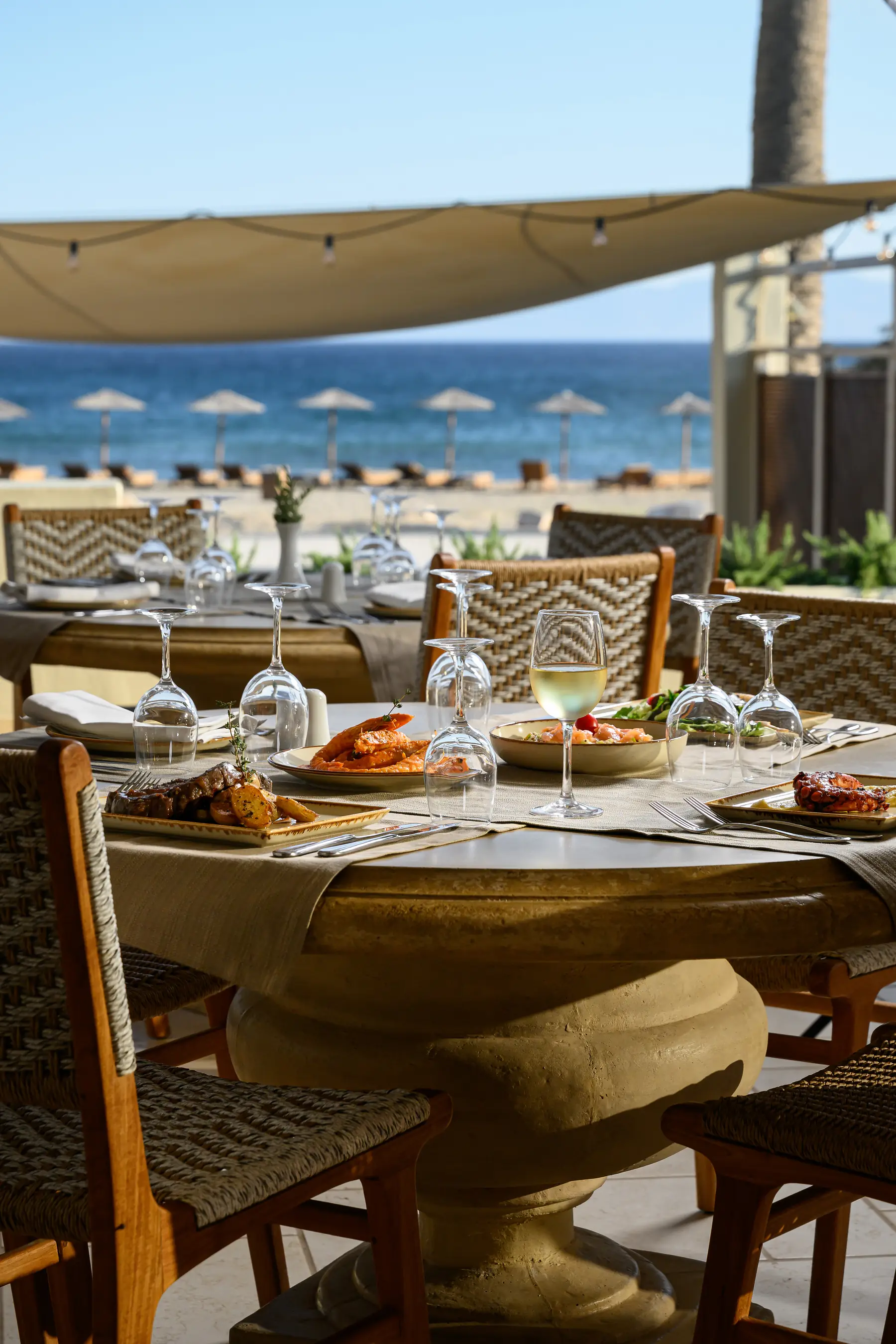 Daytime view of Avgi terrace dining by the beach in Pyrgaki, Naxos